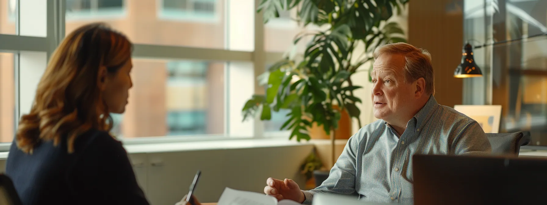 a financial broker discussing investment options with a client in an office setting.