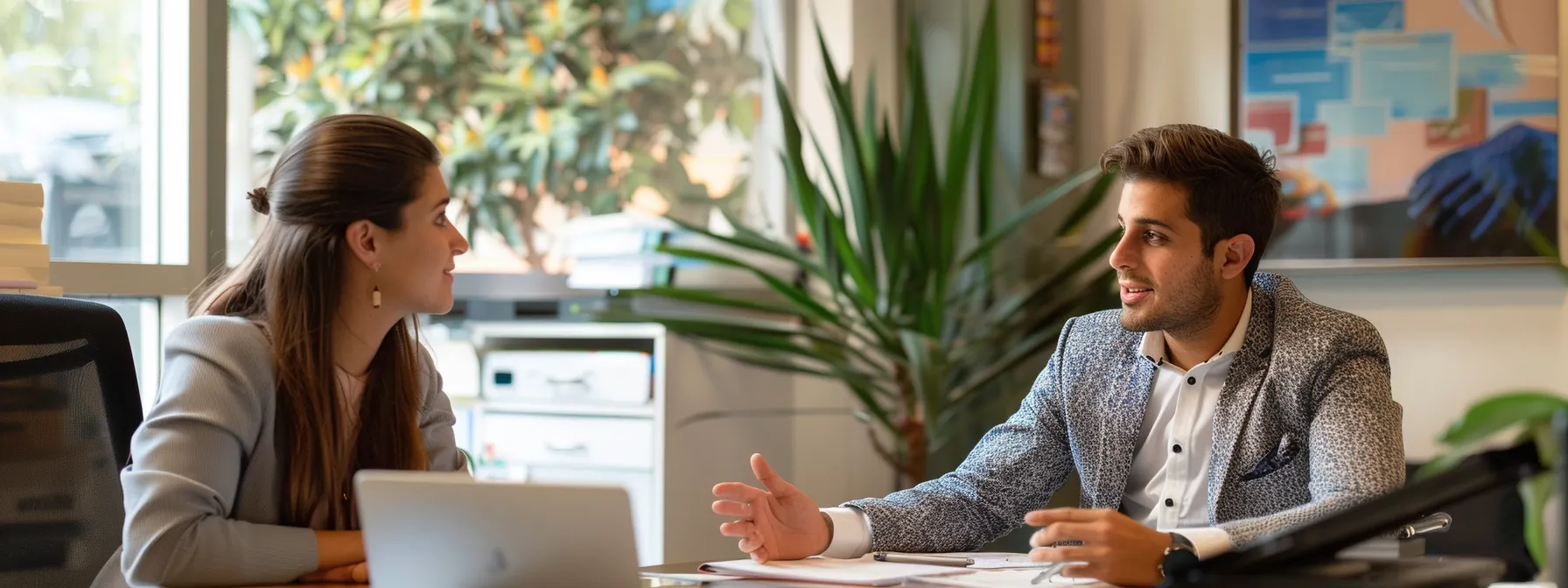 a finance broker in singleton discussing financial strategies with a business owner in an office.